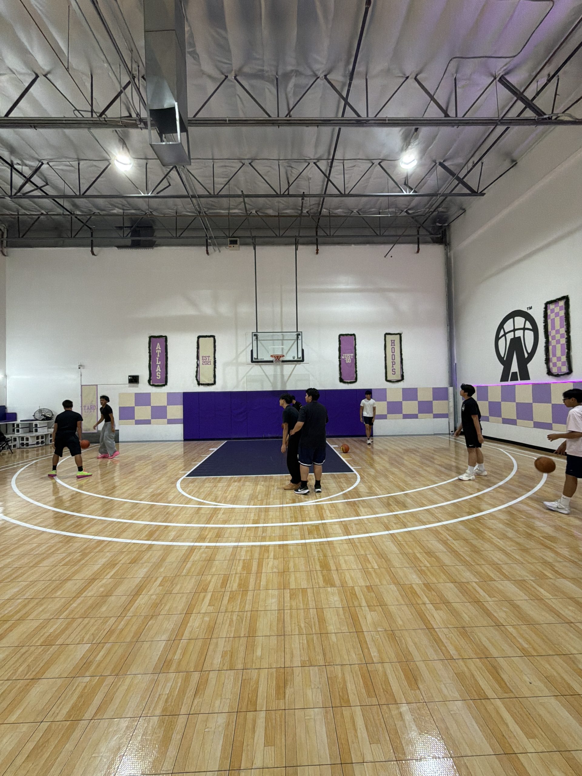 the full court at ATLAS Hoops with players warming up